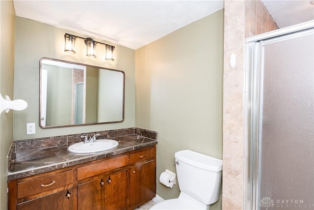 full bath featuring a stall shower, vanity, and toilet