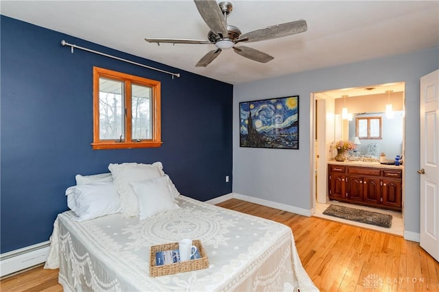 bedroom with baseboards, a baseboard radiator, connected bathroom, and light wood-style floors