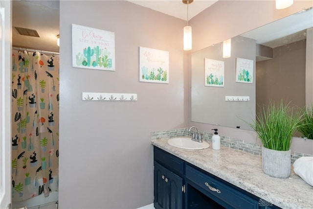 full bathroom featuring visible vents, vanity, and a shower with curtain