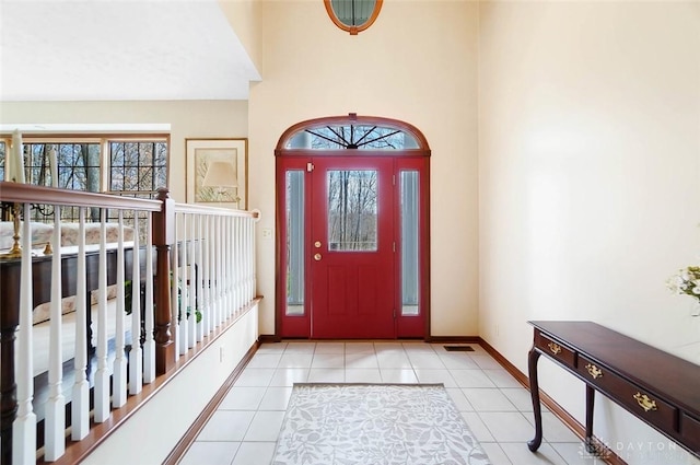 foyer entrance with light tile patterned floors and plenty of natural light