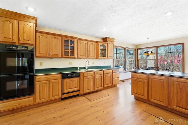 kitchen with sink, light hardwood / wood-style flooring, double oven, pendant lighting, and paneled dishwasher