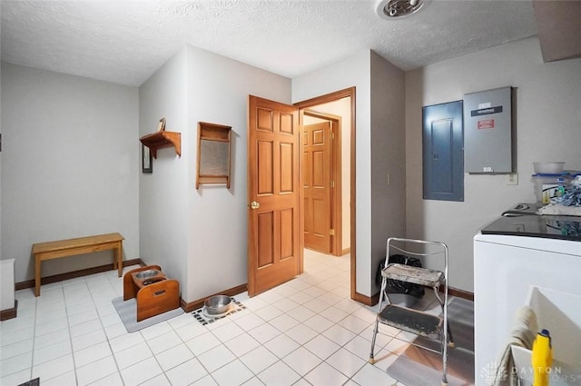 laundry area featuring light tile patterned flooring, washer / clothes dryer, electric panel, and a textured ceiling