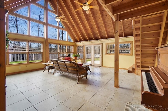 sunroom / solarium featuring wood ceiling, ceiling fan, plenty of natural light, and vaulted ceiling with beams