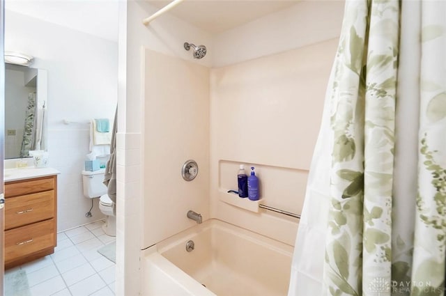 full bathroom with shower / tub combo with curtain, tile walls, vanity, tile patterned floors, and toilet