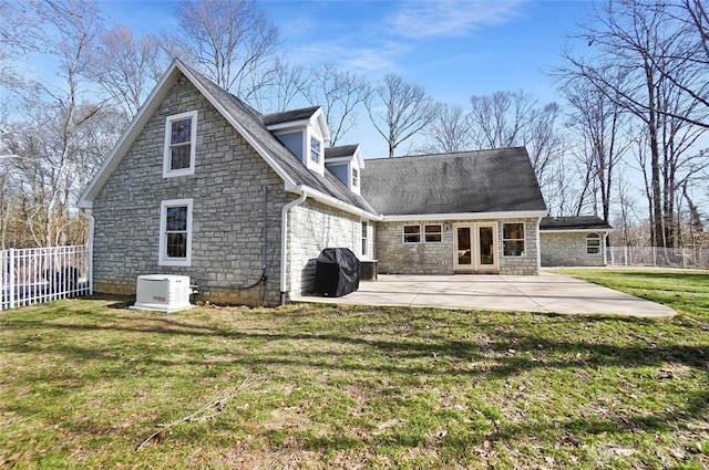 rear view of house featuring a yard, a patio area, and french doors