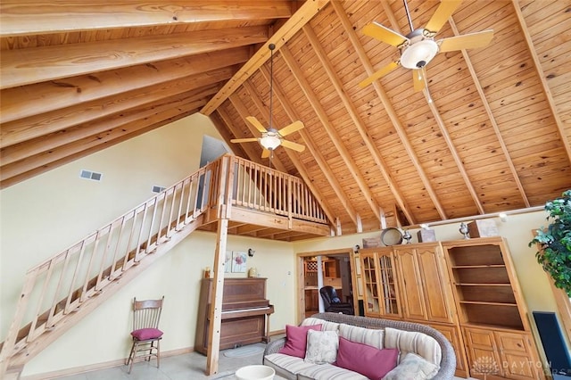 unfurnished living room featuring beamed ceiling, ceiling fan, wood ceiling, and high vaulted ceiling