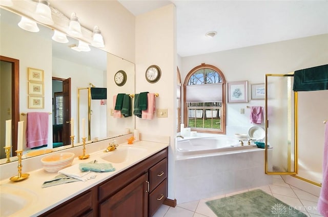 bathroom featuring tile patterned floors, separate shower and tub, and vanity