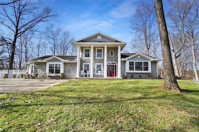 greek revival inspired property featuring a front yard