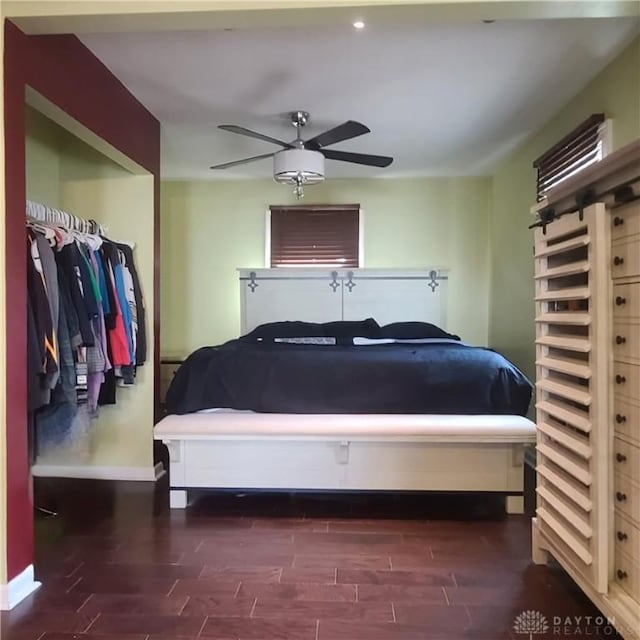 bedroom with dark hardwood / wood-style floors and ceiling fan