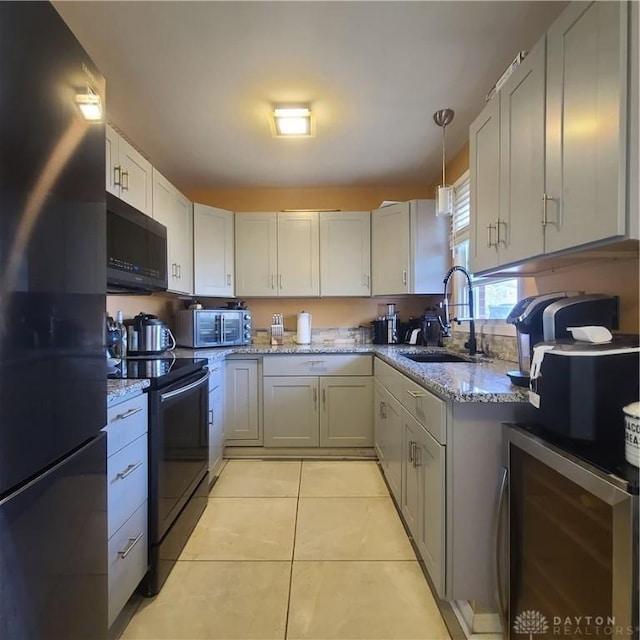 kitchen with appliances with stainless steel finishes, pendant lighting, sink, white cabinets, and beverage cooler