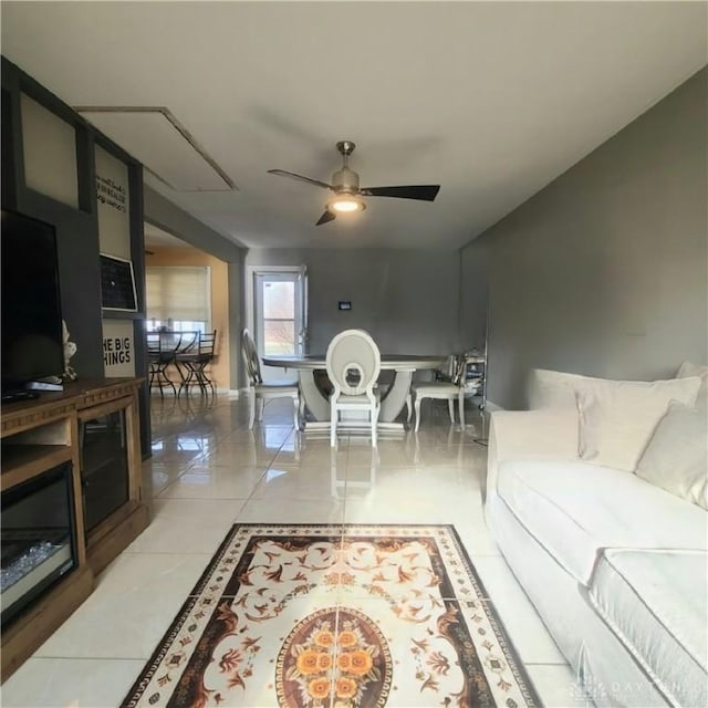 tiled living room featuring ceiling fan