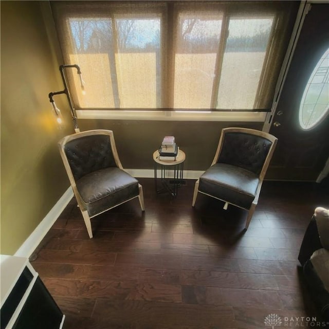 sitting room with dark wood-type flooring