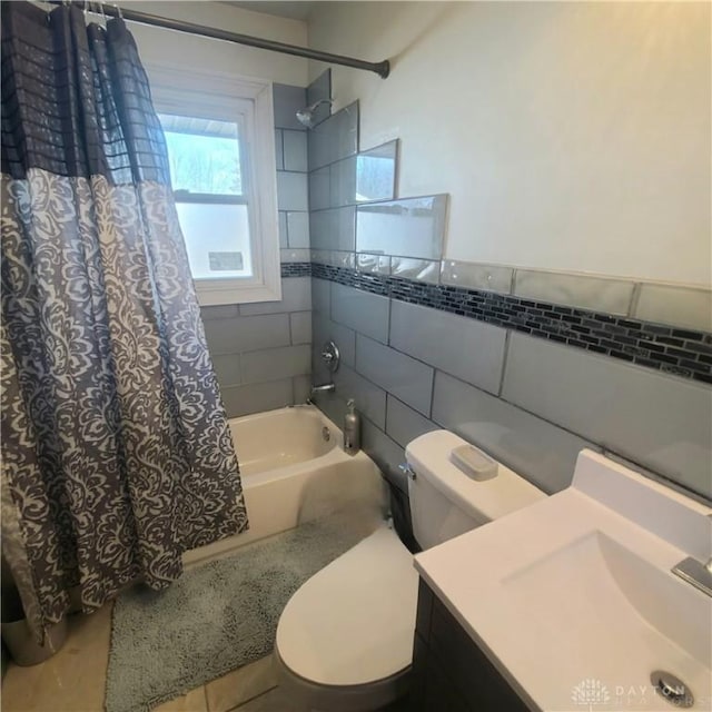 full bathroom featuring shower / tub combo, vanity, toilet, and tile walls