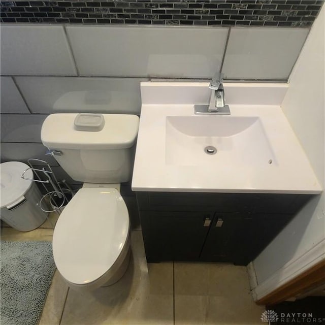 bathroom featuring vanity, toilet, and tile patterned flooring