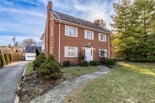 colonial home with a garage and a front yard