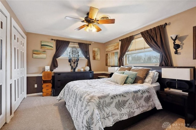 bedroom featuring ceiling fan, a closet, and light carpet