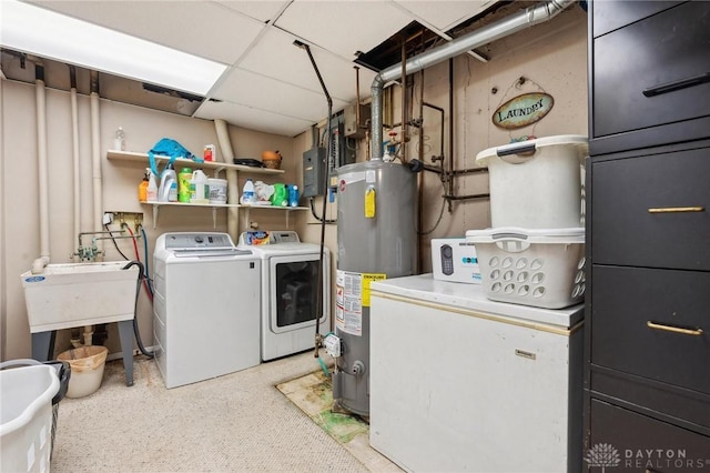 clothes washing area featuring separate washer and dryer, sink, and gas water heater