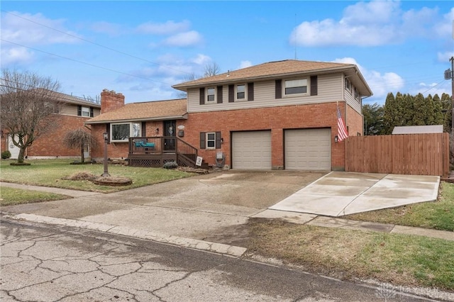 view of front of property featuring a wooden deck, a garage, and a front lawn