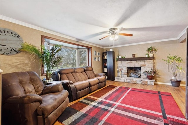 living room featuring crown molding, ceiling fan, a fireplace, and hardwood / wood-style floors