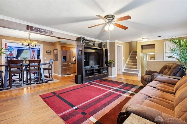 living room featuring crown molding, ceiling fan with notable chandelier, and hardwood / wood-style floors