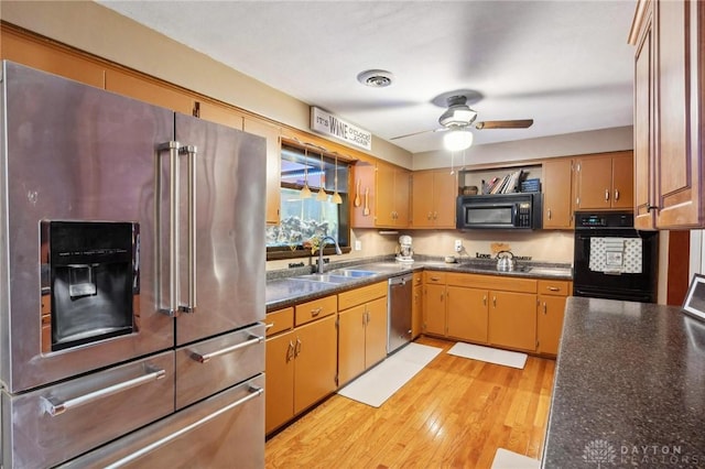 kitchen with ceiling fan, sink, light hardwood / wood-style floors, and black appliances