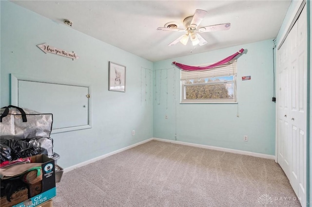 unfurnished bedroom featuring carpet floors, ceiling fan, and a closet