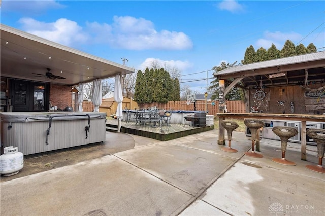 view of patio featuring a hot tub and ceiling fan