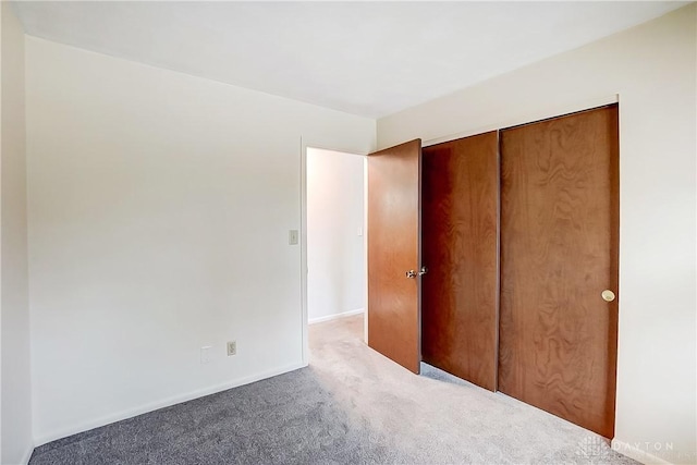 unfurnished bedroom featuring a closet and carpet flooring