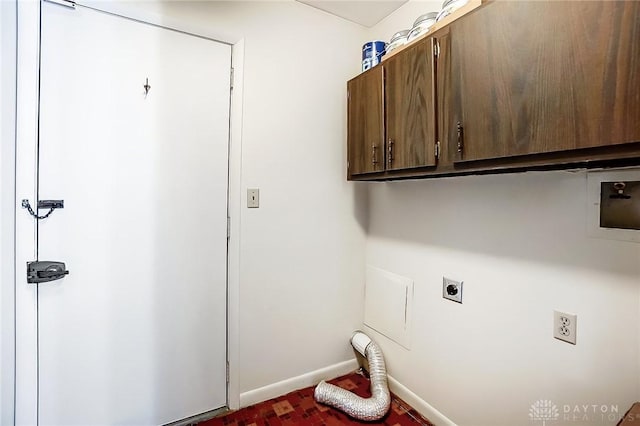 clothes washing area featuring electric dryer hookup, washer hookup, and cabinets