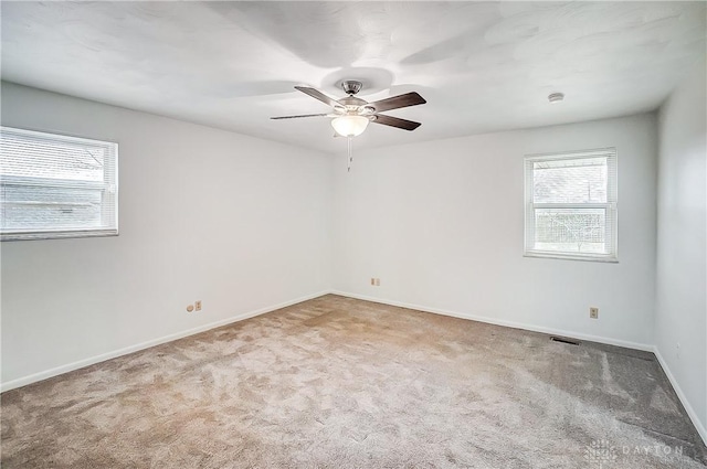 spare room with ceiling fan and carpet flooring