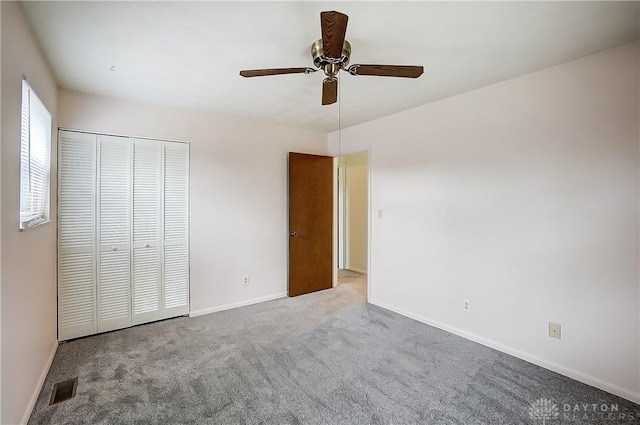 unfurnished bedroom with light colored carpet, ceiling fan, and a closet