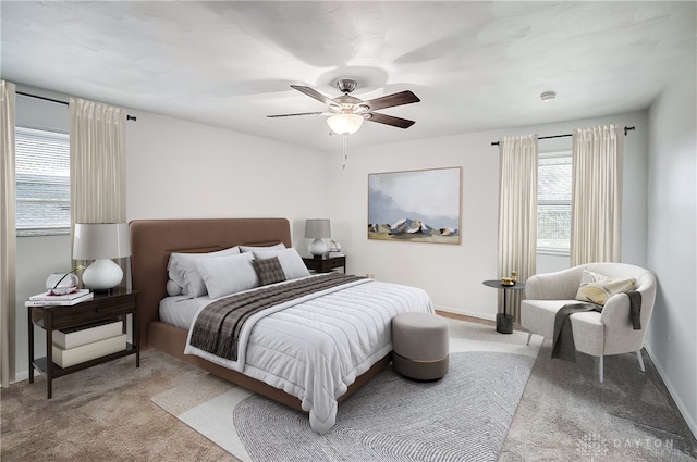 bedroom featuring light colored carpet and ceiling fan