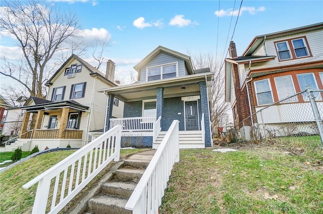 view of front of house featuring a front yard and a porch