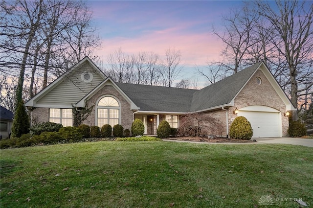 view of front of property featuring a garage and a yard