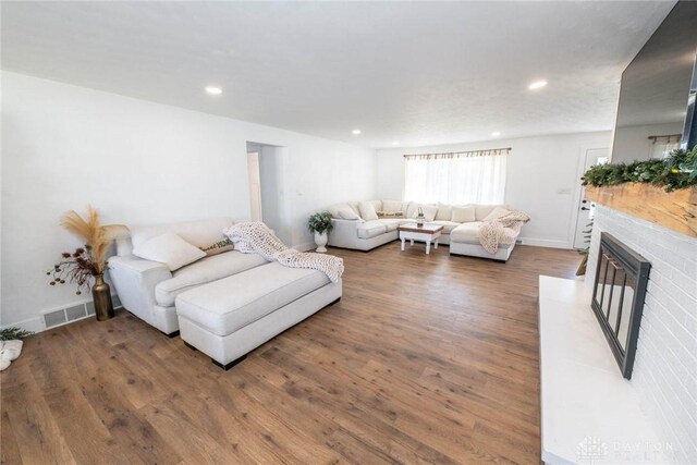 330 W Spring St, Eaton, OH 45320 - living area with a glass covered fireplace, wood finished floors, recessed lighting, and baseboards