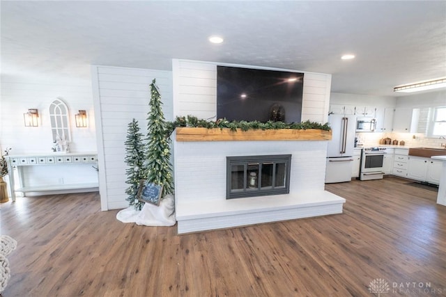 330 W Spring St, Eaton, OH 45320 - living room featuring a glass covered fireplace, dark wood finished floors, and recessed lighting