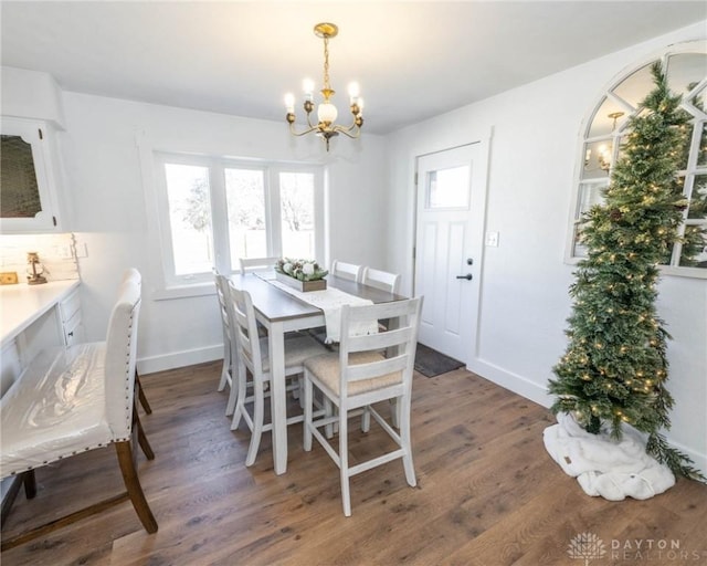 330 W Spring St, Eaton, OH 45320 - dining space with a chandelier, wood finished floors, and plenty of natural light