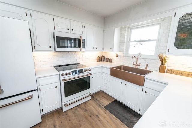 330 W Spring St, Eaton, OH 45320 - kitchen with white appliances, a sink, backsplash, and dark wood finished floors