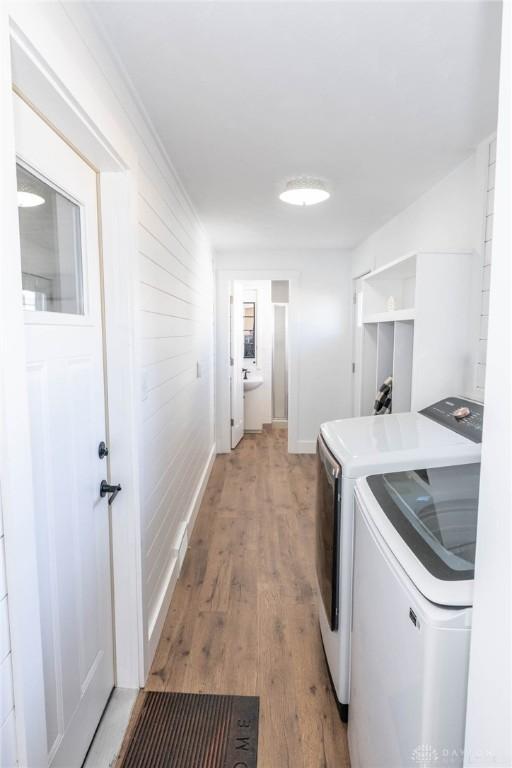 330 W Spring St, Eaton, OH 45320 - laundry room with washing machine and dryer, light wood finished floors, and baseboards