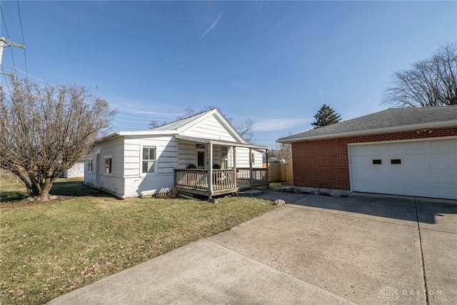 330 W Spring St, Eaton, OH 45320 - view of front of home with a front yard, driveway, and brick siding