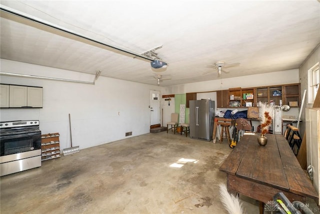 330 W Spring St, Eaton, OH 45320 - garage with freestanding refrigerator, a garage door opener, and ceiling fan