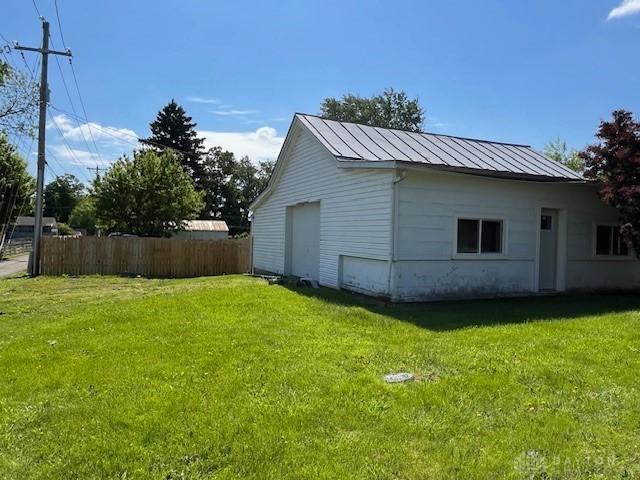 330 W Spring St, Eaton, OH 45320 - view of side of home featuring a detached garage, a standing seam roof, and metal roof