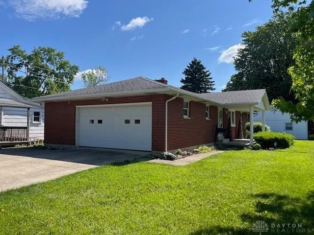 330 W Spring St, Eaton, OH 45320 - ranch-style house with a front yard, an attached garage, brick siding, and a chimney