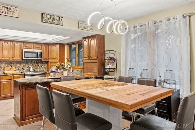 tiled dining space featuring a tray ceiling