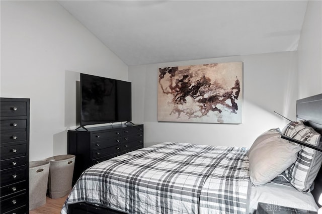 bedroom featuring hardwood / wood-style flooring and vaulted ceiling