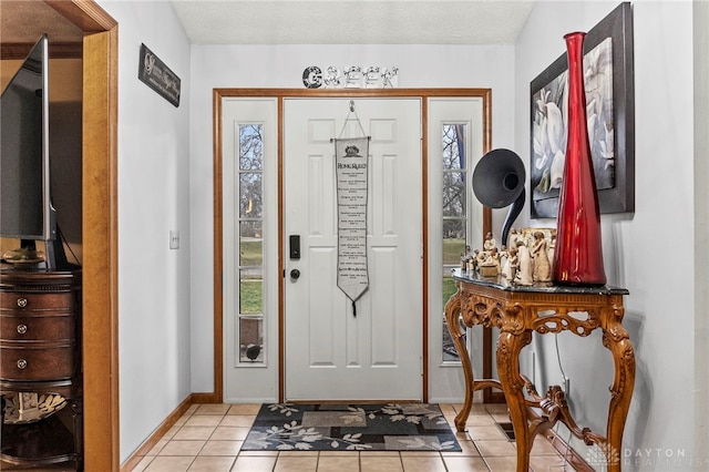 tiled foyer with a textured ceiling