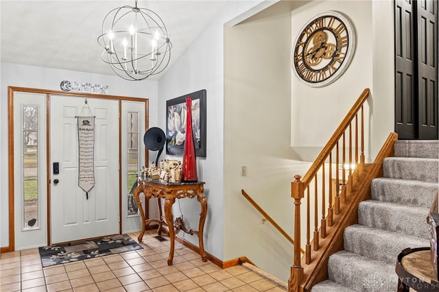 tiled foyer entrance featuring a notable chandelier