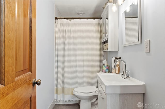 bathroom with vanity, toilet, and curtained shower