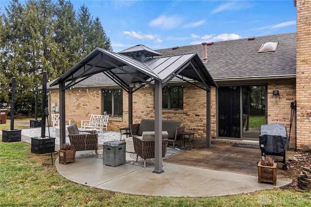 view of patio / terrace featuring a gazebo, area for grilling, and an outdoor living space with a fire pit