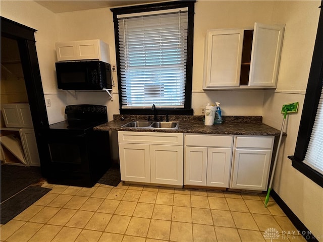 kitchen featuring sink, white cabinets, and black appliances